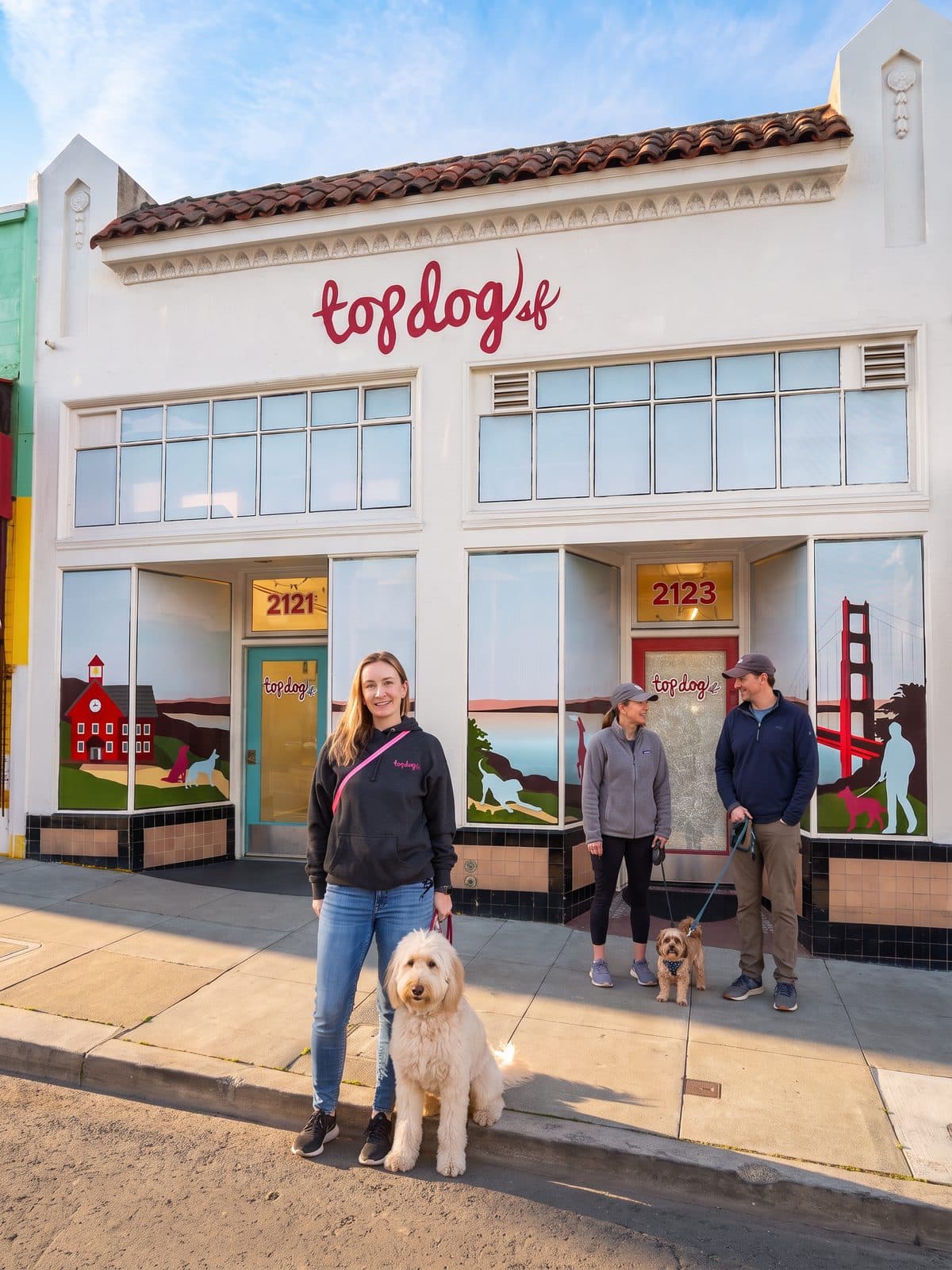 Natalie and the Top Dog SF team with their dogs outside the Taraval Street storefront